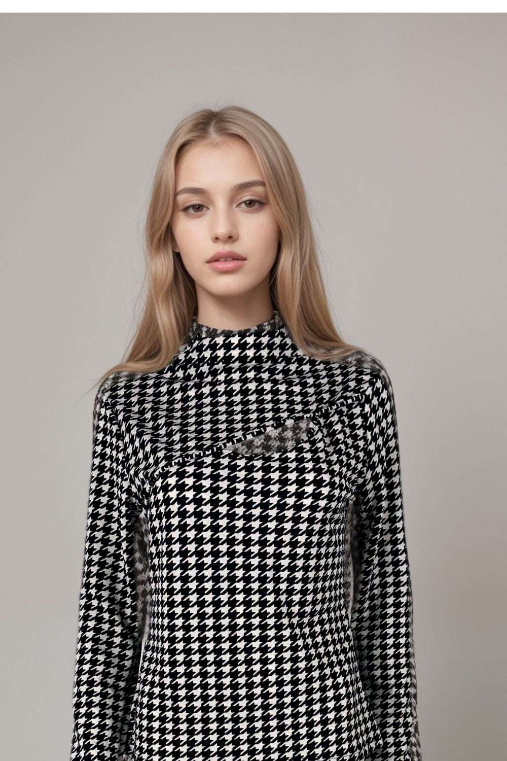 Black and white houndstooth long sleeve top with high neckline and mesh panel