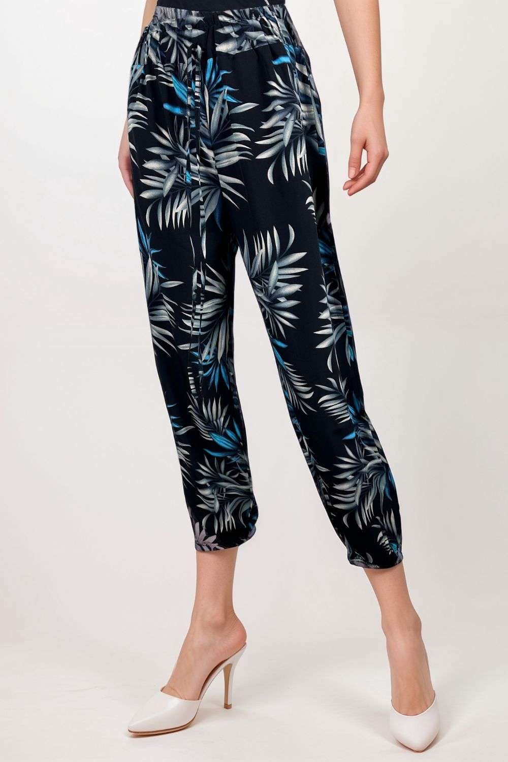 Black tropical print trousers with blue and grey palm leaf design and elastic waist