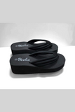 Pair of black wedge platform flip flops with cushioned straps