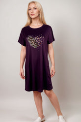 Woman in a purple lounge dress with leopard print heart graphic