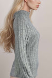 Woman wearing a grey ribbed knit high neck long sleeve top