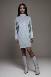 Woman wearing a grey ribbed knit sweater dress with high neck and boots