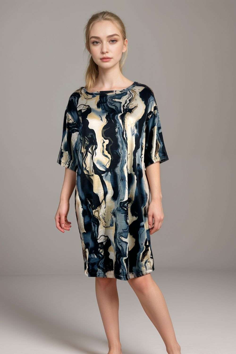 Woman wearing abstract marble print satin lounge dress in dark blue and creamSatin Nightdress In Marble Print