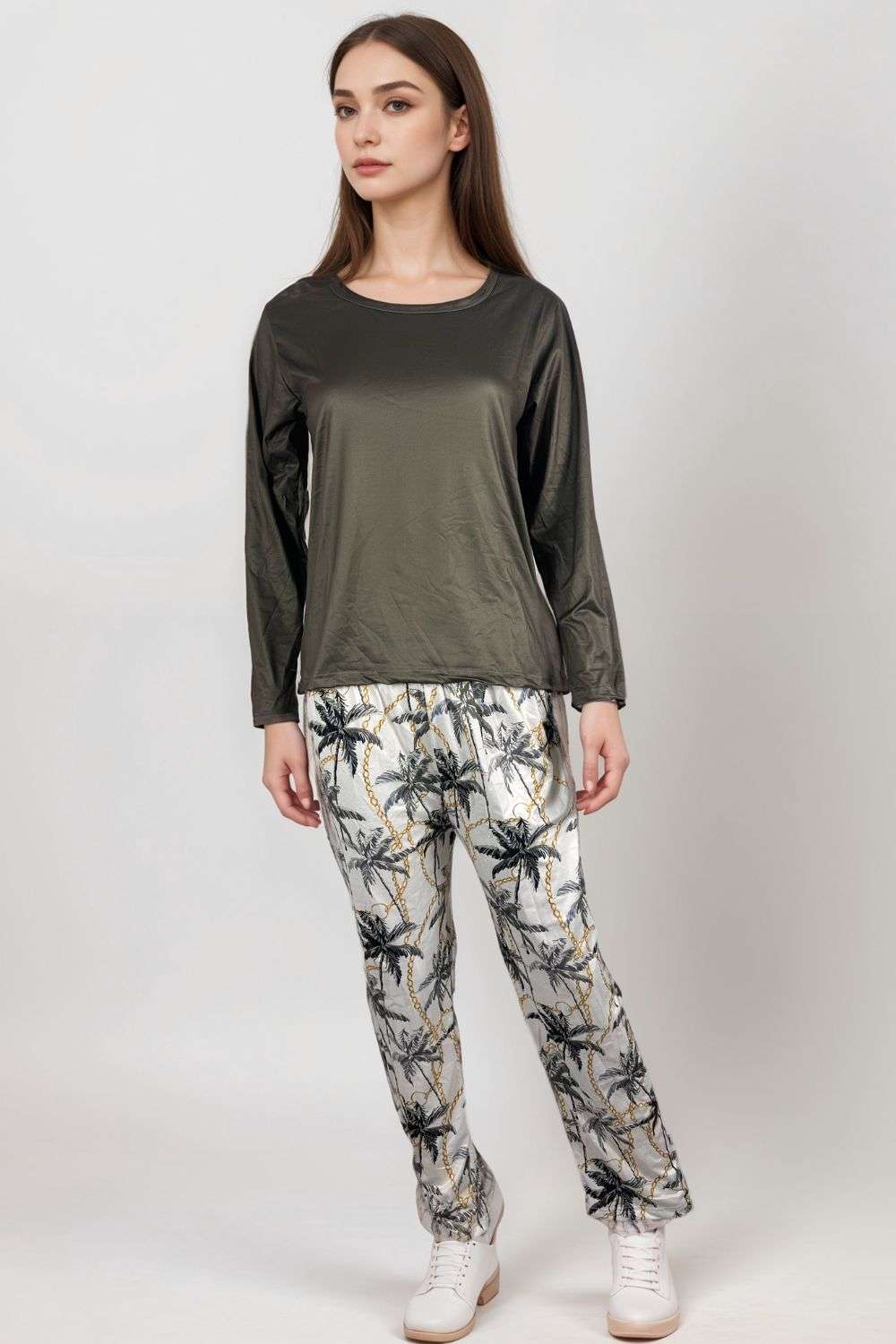 Woman wearing olive satin long-sleeve top and palm tree print lounge trousers