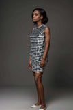 Woman wearing sleeveless black and white houndstooth mini bodycon dress