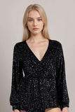 Woman wearing black glitter bodysuit with long sleeves and plunge necklineGlitter Long Sleeve Top