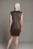 Back view of a sleeveless black and white houndstooth bodycon mini dress, showcasing its sleek fit and stylish design.
