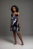 Black satin mini slip dress with white floral print and spaghetti straps
