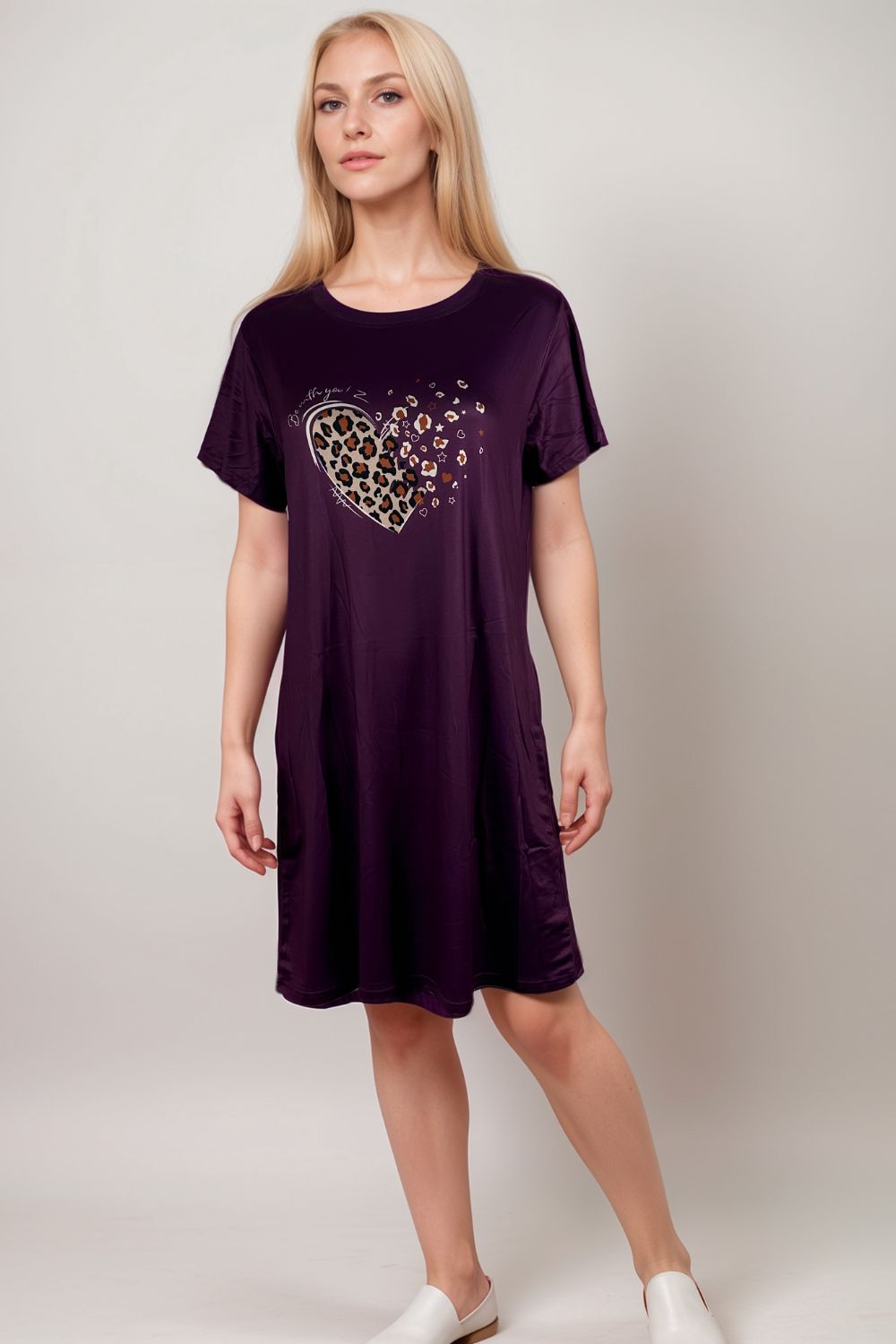 Woman in a purple lounge dress with leopard print heart graphic
