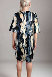 Satin Nightdress In Marble PrintWoman wearing abstract marble print satin lounge dress in dark blue and cream