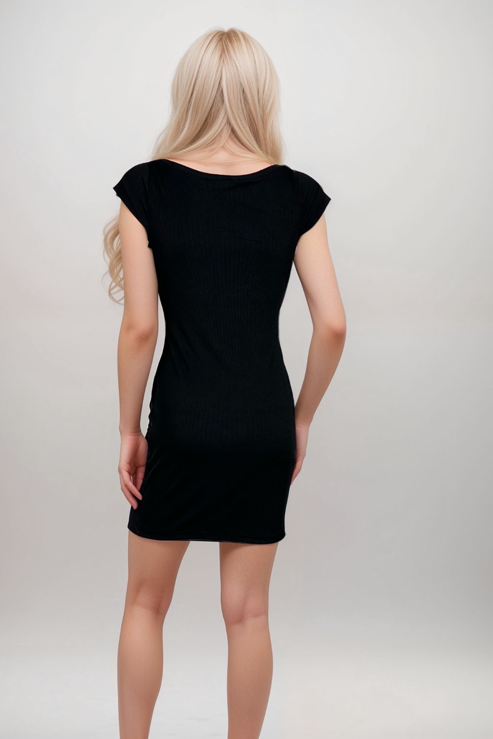 Woman wearing black sweetheart neck bodycon mini dress with wide straps